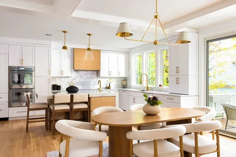 a kitchen with a dining table chairs and a dining table with wooden floor