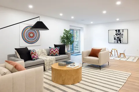 a living room with furniture and a rug