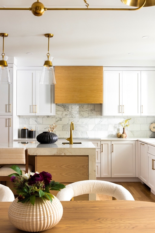 85 Naples Road, Unit 2 Brookline, MA 02446 - Photo 3 of 28 a kitchen with stainless steel appliances granite countertop a sink dishwasher a stove and white cabinets with wooden floor