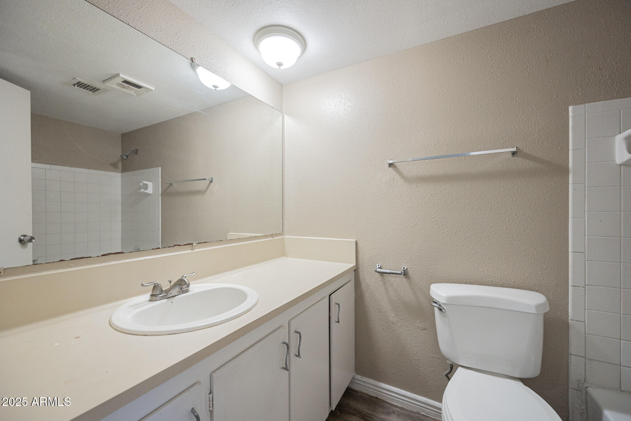 2411 West Hazelwood Street, Unit 278 Phoenix, AZ 85015 - Photo 19 of 20 a bathroom with a toilet sink and mirror