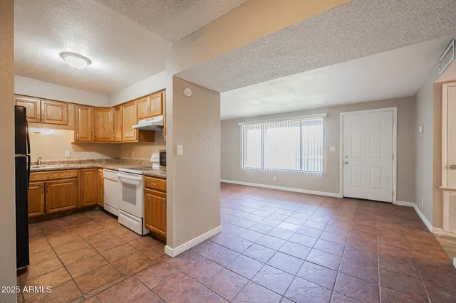 a kitchen with a stove a sink and a refrigerator