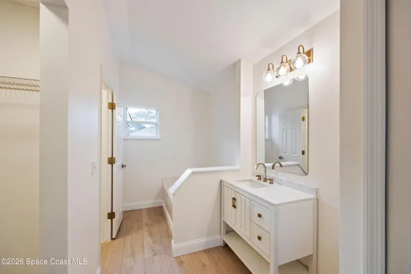 a spacious bathroom with a double vanity sink and mirror
