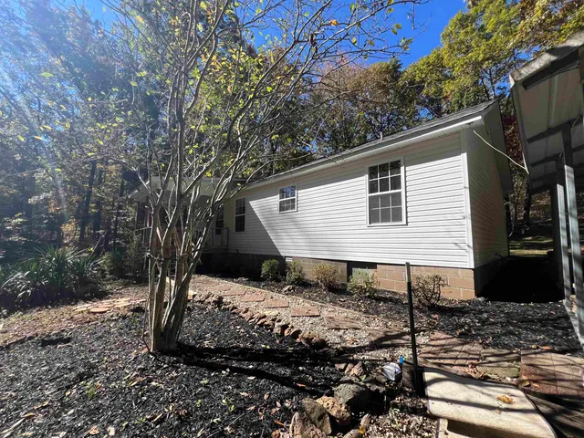 a backyard of a house with wooden fence