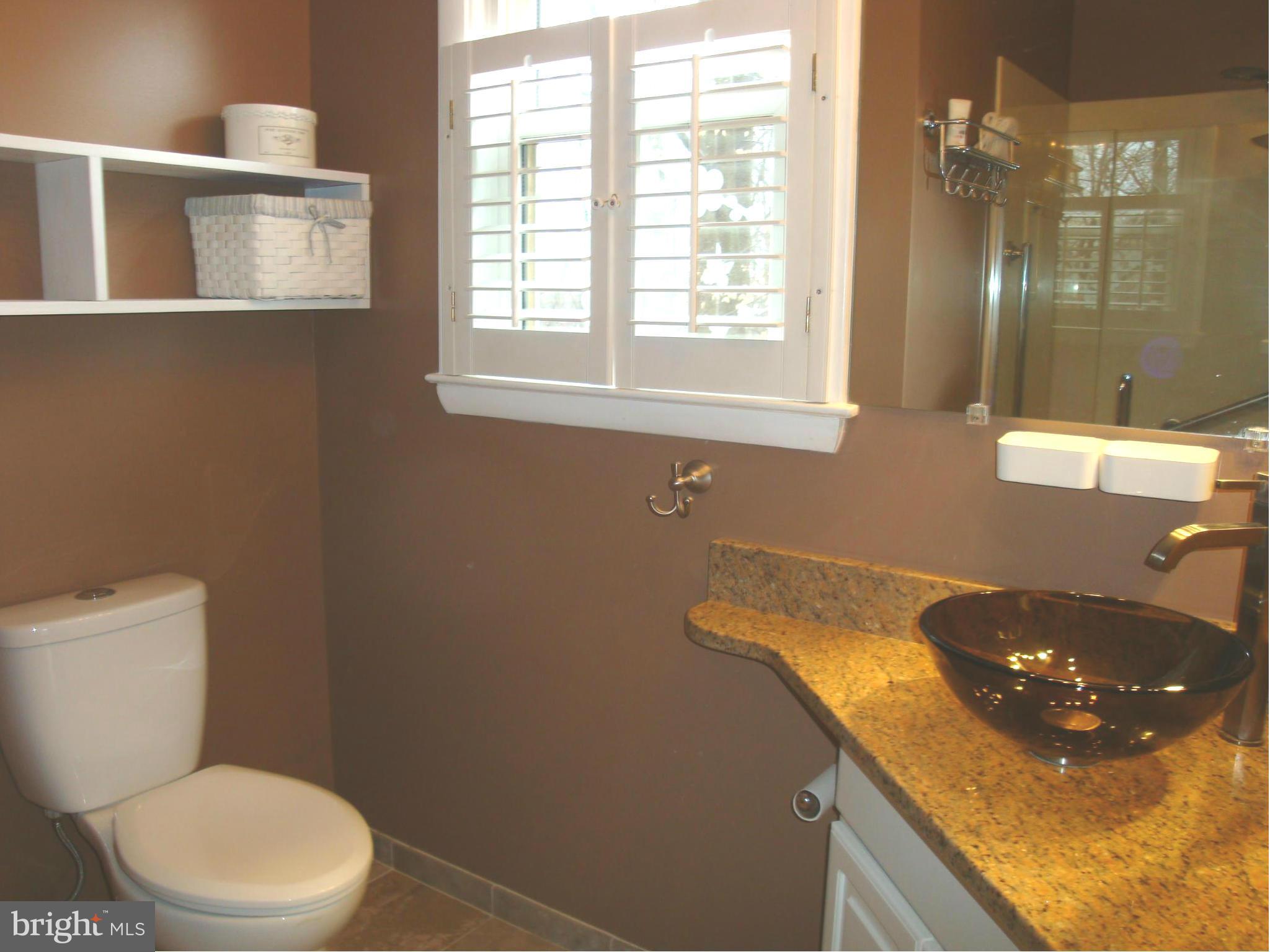 901 Huntsman Road Towson, MD 21286 - Photo 14 of 30 a bathroom with a granite countertop sink a toilet and a mirror