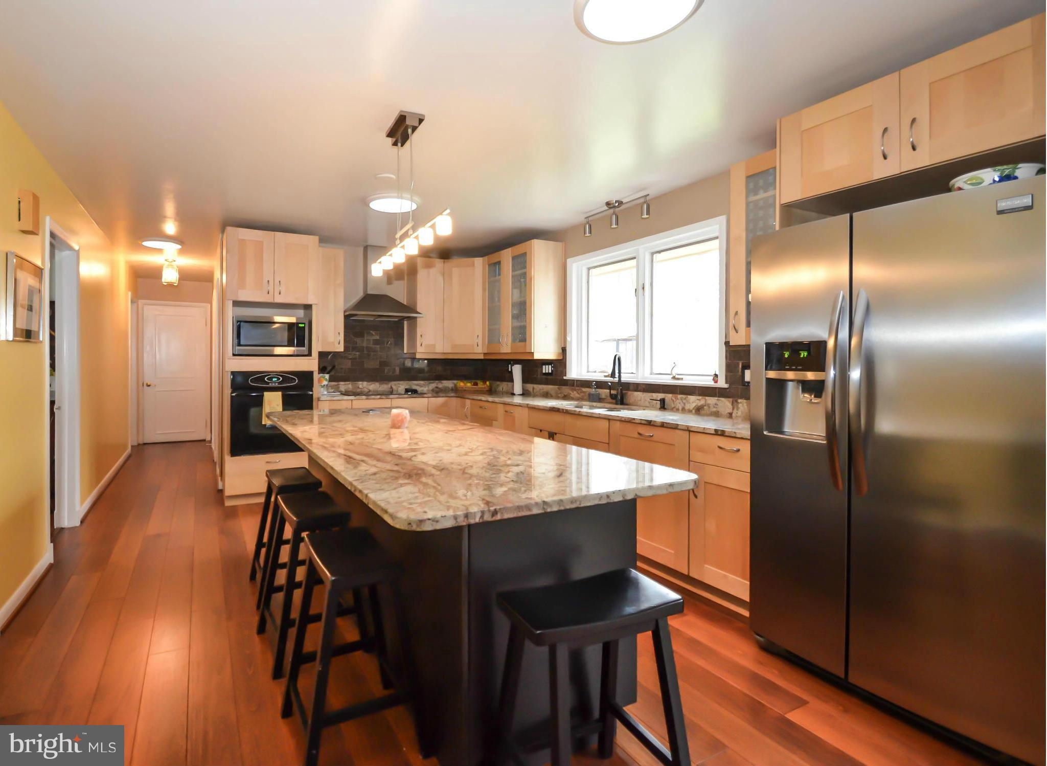 901 Huntsman Road Towson, MD 21286 - Photo 3 of 30 a kitchen with stainless steel appliances granite countertop a refrigerator a sink dishwasher a stove and a refrigerator with wooden floor