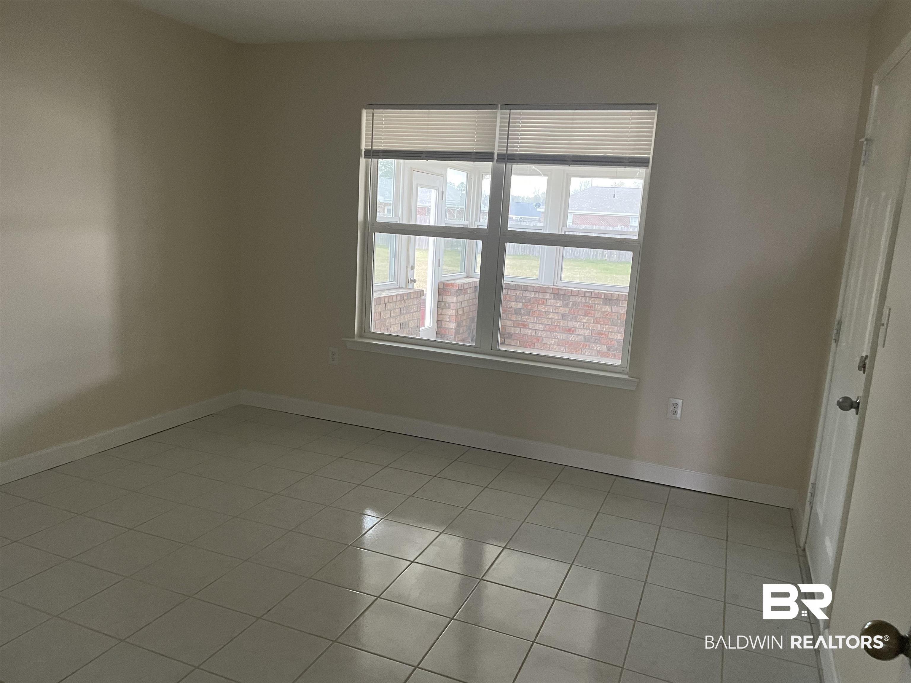 23575 Fountain Street Robertsdale, AL 36567 - Photo 2 of 19 Bedroom featuring baseboards and light tile patterned floors