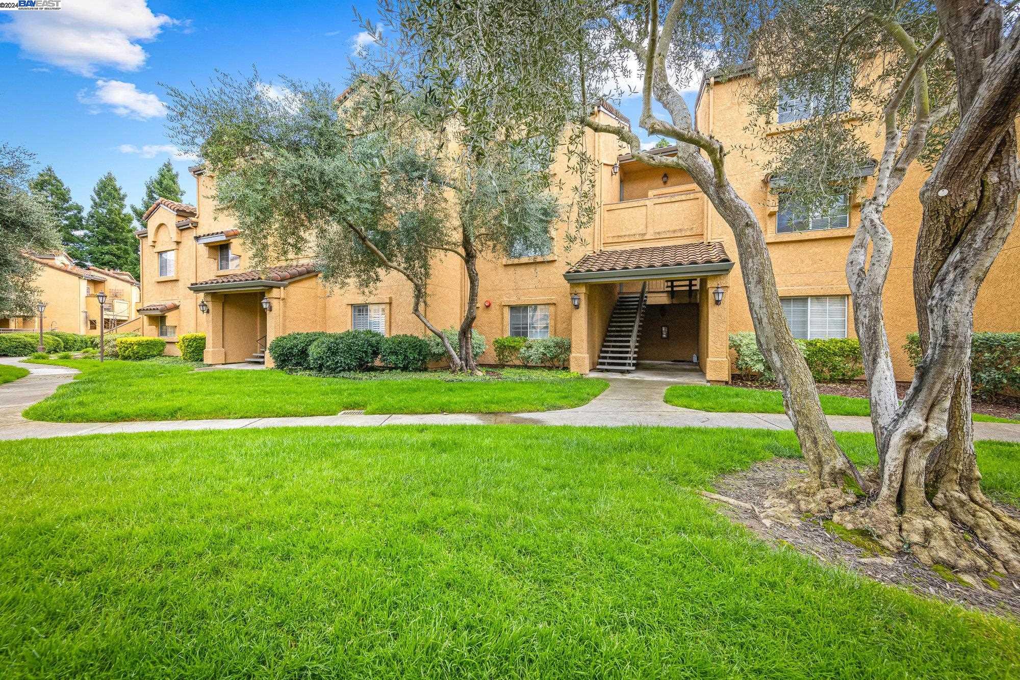 725 Watson Canyon Court, Unit 316 San Ramon, CA 94582 - Photo 1 of 1 a front view of a house with garden and trees