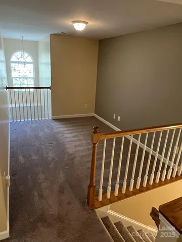 a view of staircase with wooden floor and a window