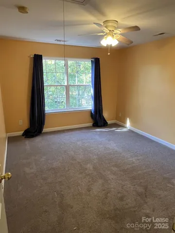 a view of room with window and ceiling fan