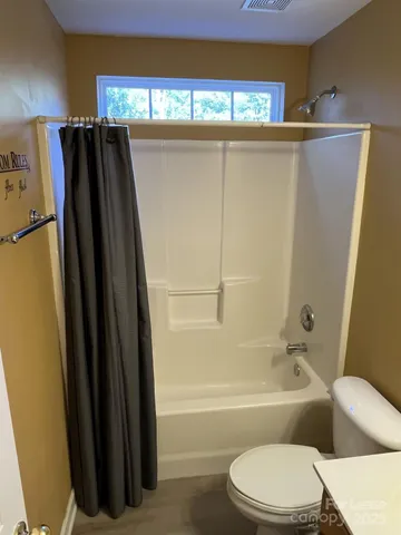 a bathroom with a toilet and a bathtub