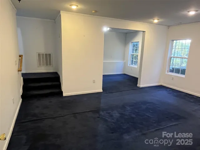 a view of a hallway with wooden floor and entryway