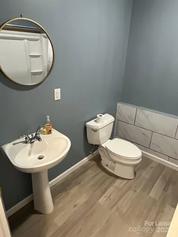 a bathroom with a toilet sink and mirror