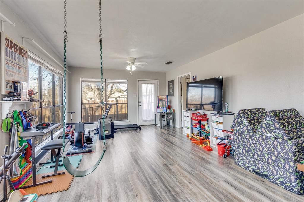 1304 South Hatcher Street Decatur, TX 76234 - Photo 16 of 36 a view of a livingroom with furniture hardwood floor and a flat screen tv