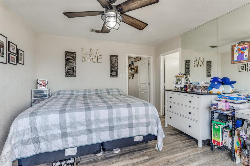 1304 South Hatcher Street Decatur, TX 76234 - Photo 18 of 36 a bedroom with a bed and wooden floor