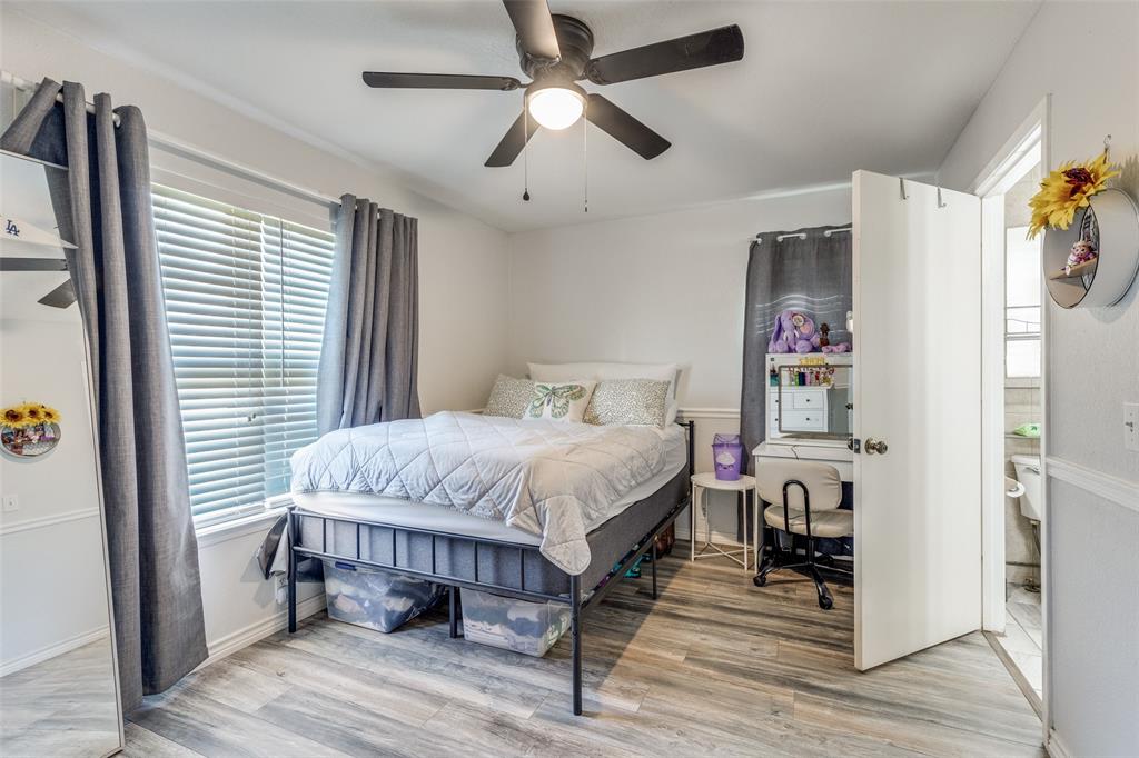 1304 South Hatcher Street Decatur, TX 76234 - Photo 20 of 36 a spacious bedroom with a bed and a chandelier