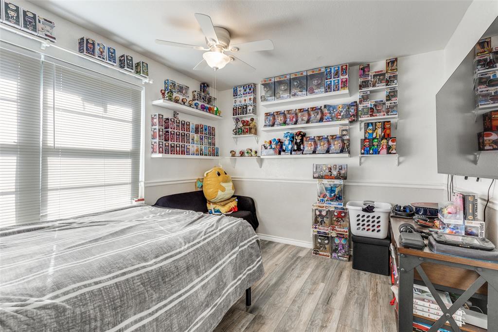 1304 South Hatcher Street Decatur, TX 76234 - Photo 22 of 36 a bedroom with furniture and a book shelf