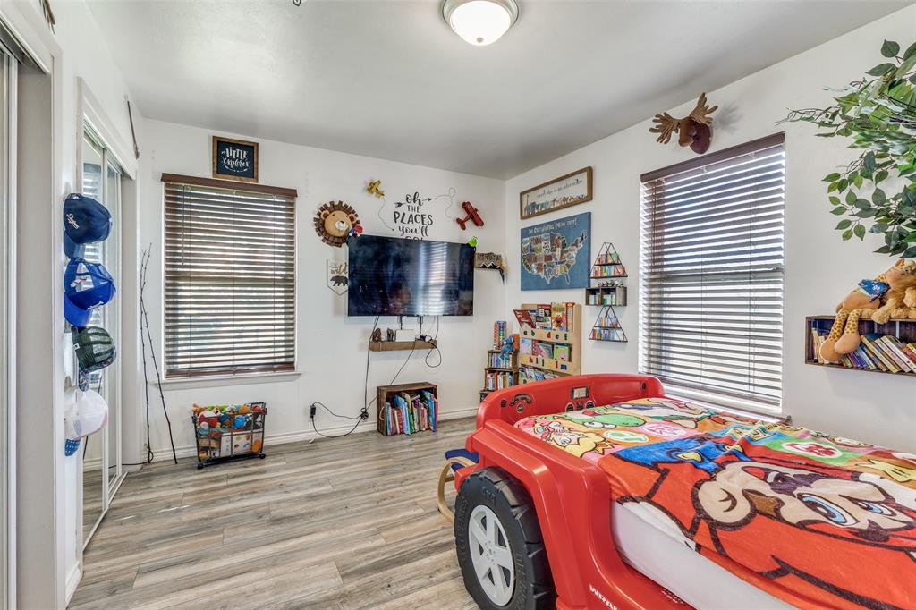 1304 South Hatcher Street Decatur, TX 76234 - Photo 23 of 36 a bedroom with a bed and a tv in it