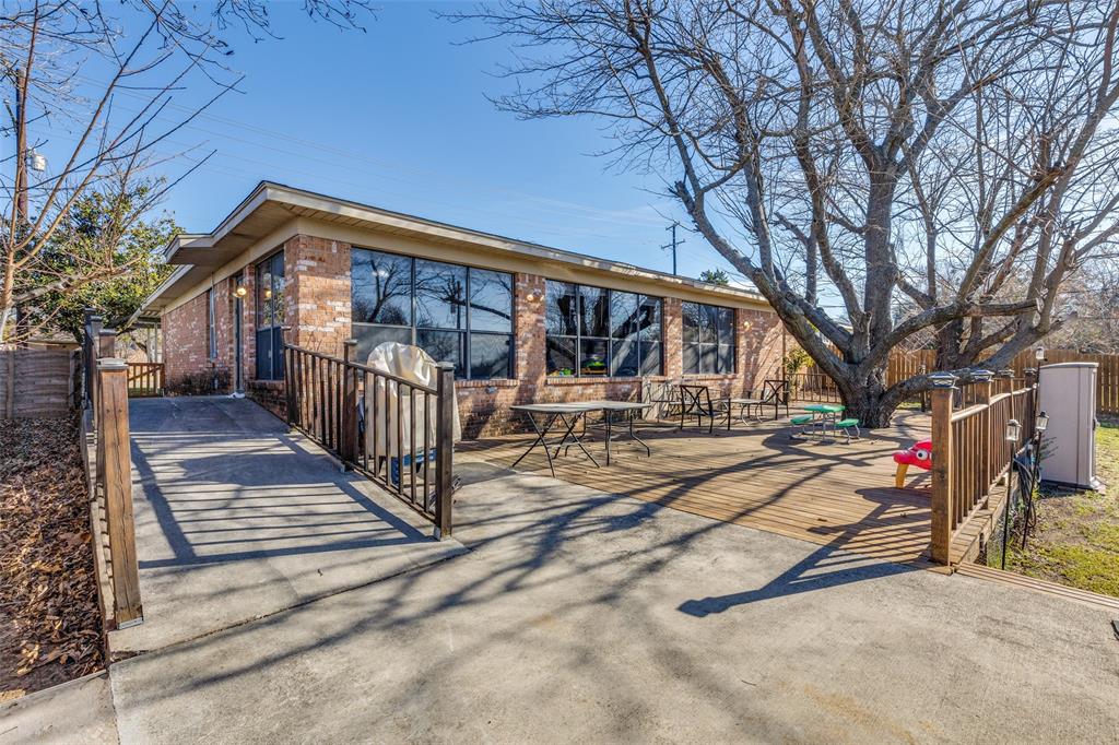 1304 South Hatcher Street Decatur, TX 76234 - Photo 27 of 36 a view of a house with wooden deck next to a road
