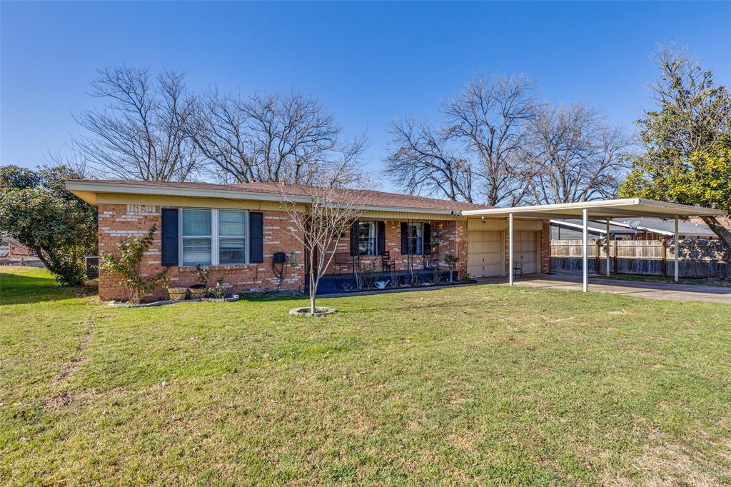 1304 South Hatcher Street Decatur, TX 76234 - Photo 3 of 36 a front view of a house with a garden