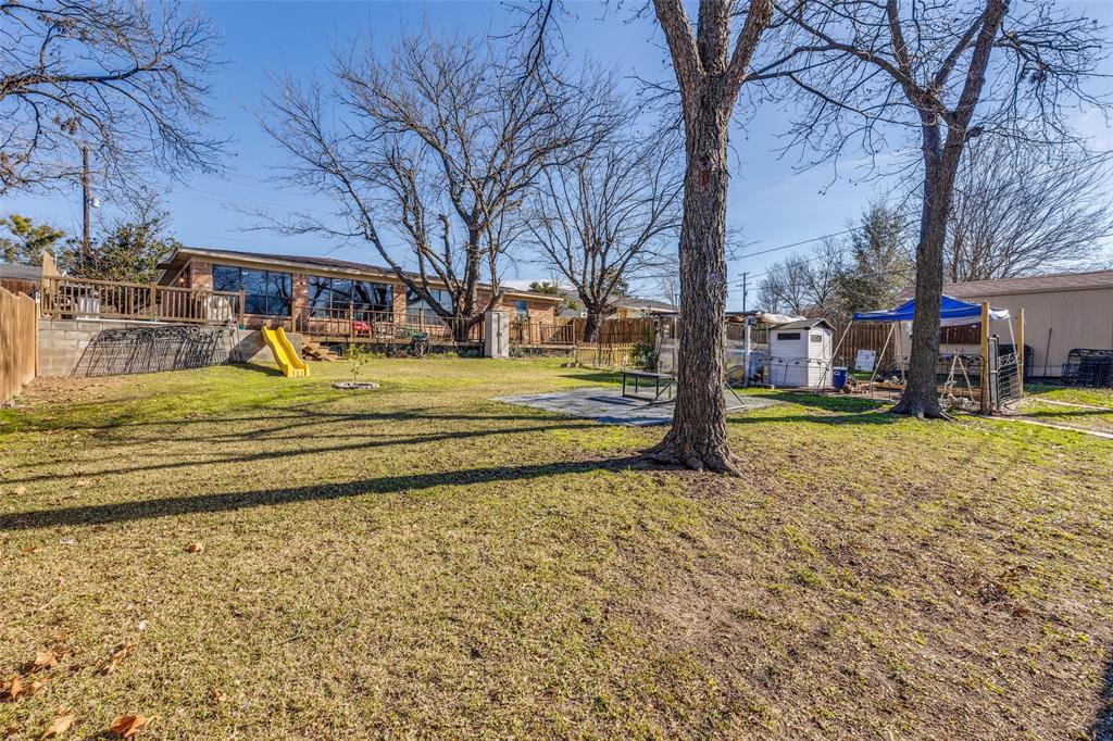 1304 South Hatcher Street Decatur, TX 76234 - Photo 31 of 36 a view of a yard with tree s