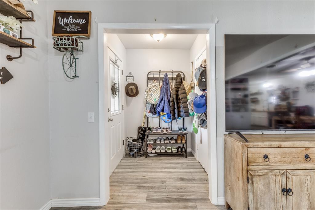 1304 South Hatcher Street Decatur, TX 76234 - Photo 8 of 36 a view of a hallway with wooden floor and windows