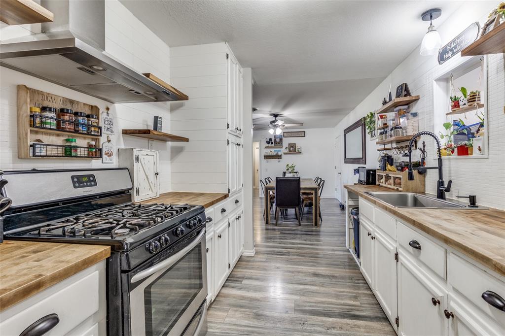 1304 South Hatcher Street Decatur, TX 76234 - Photo 10 of 36 a kitchen with stainless steel appliances granite countertop a stove and a sink