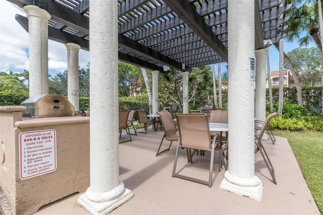 a view of a patio with table and chairs and potted plants