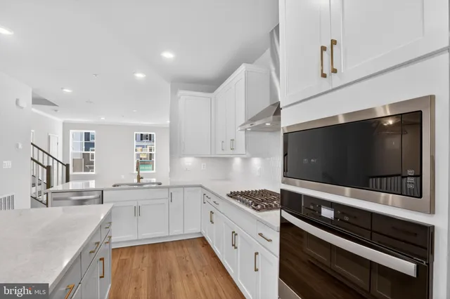 a kitchen with stainless steel appliances kitchen island granite countertop a sink and cabinets