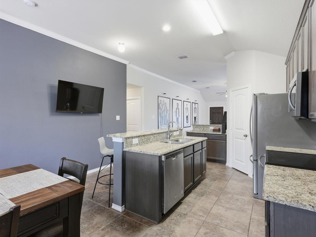 425 Merry Mill Road Wilmer, TX 75172 - Photo 11 of 29 a kitchen that has a sink and a stove in it