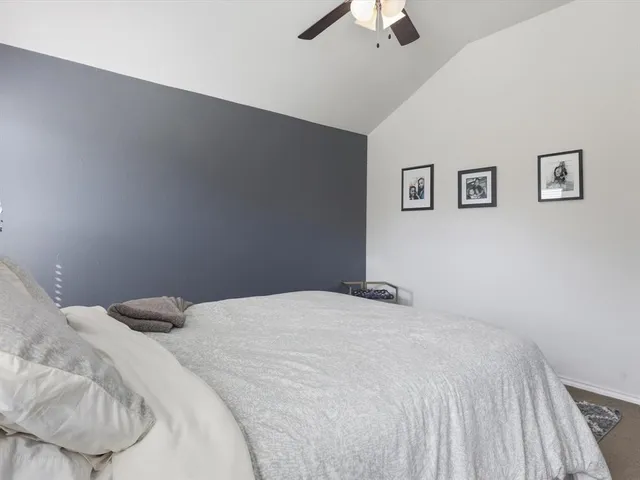 a bedroom with a bed and a chair