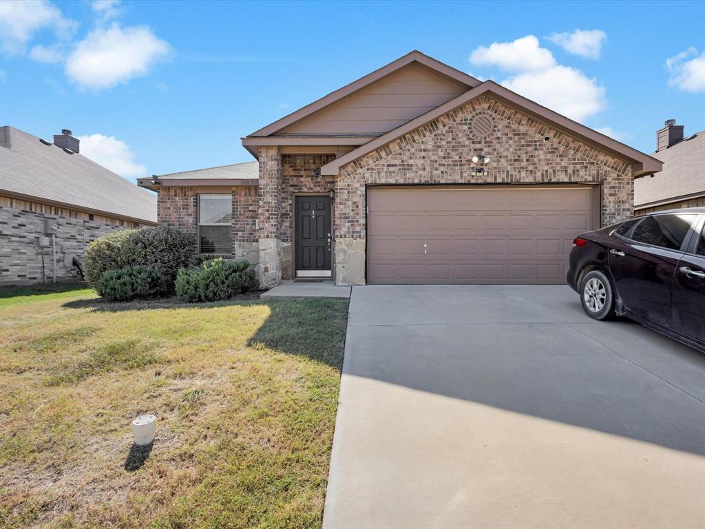 425 Merry Mill Road Wilmer, TX 75172 - Photo 2 of 29 a front view of a house with a yard and garage
