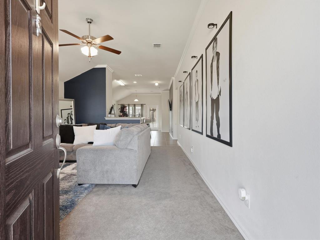 425 Merry Mill Road Wilmer, TX 75172 - Photo 3 of 29 a living room with furniture and a chandelier