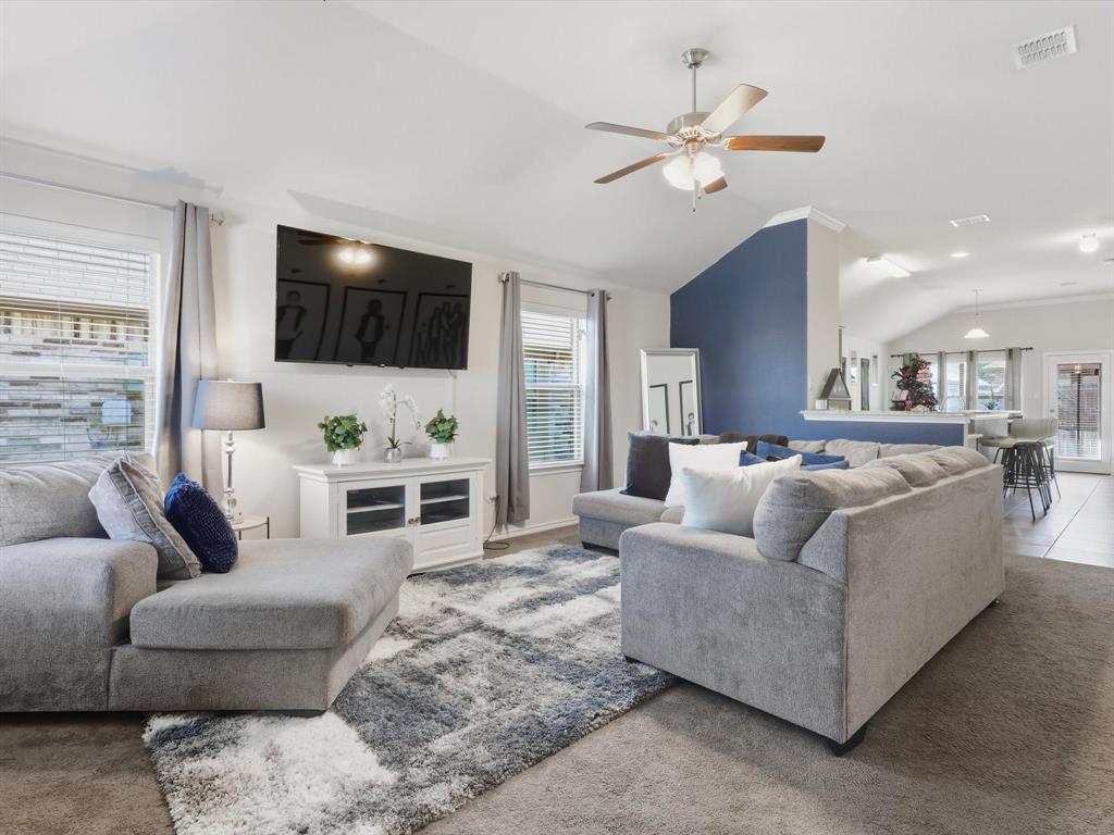 425 Merry Mill Road Wilmer, TX 75172 - Photo 5 of 29 a living room with furniture a flat screen tv and a fireplace