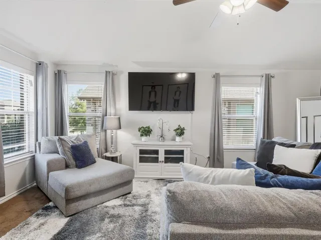 a living room with furniture and a flat screen tv