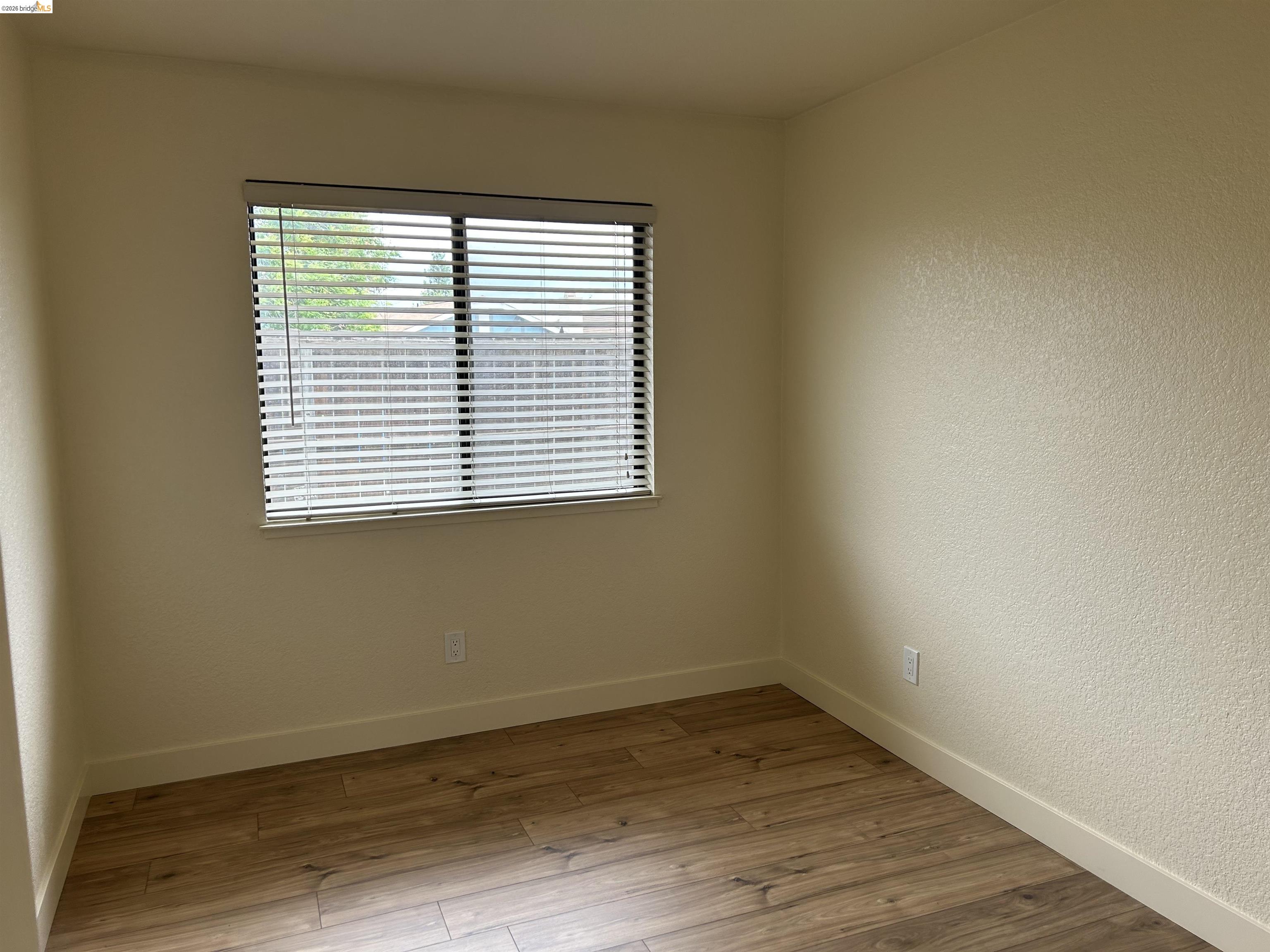 2632 Point Lobos Court Antioch, CA 94531 - Photo 15 of 27 Empty room with light wood-type flooring and a textured wall