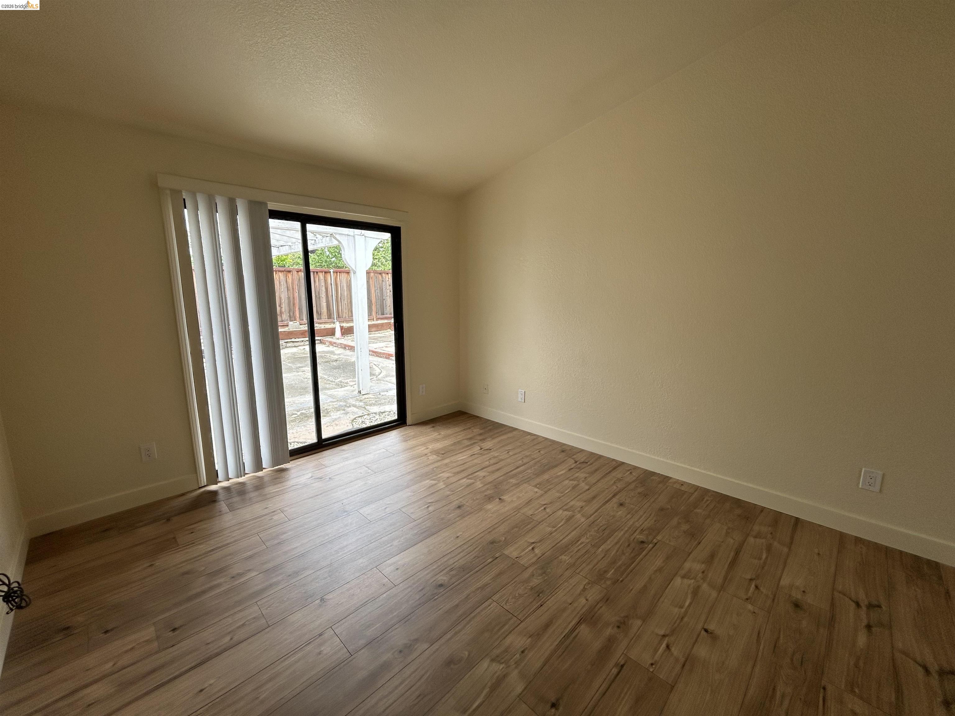 2632 Point Lobos Court Antioch, CA 94531 - Photo 18 of 27 Empty room with dark wood-type flooring and lofted ceiling