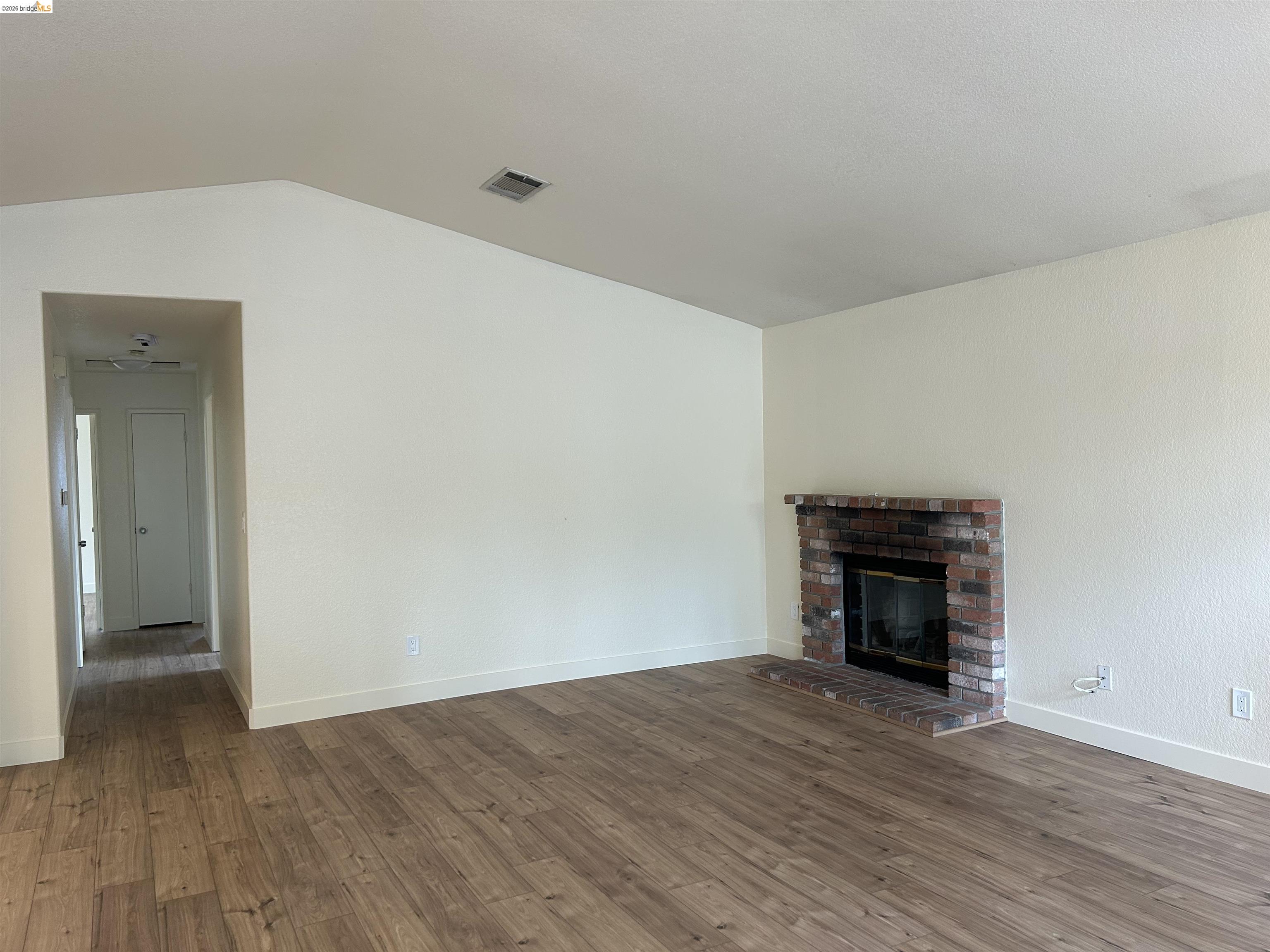 2632 Point Lobos Court Antioch, CA 94531 - Photo 4 of 27 Unfurnished living room featuring a fireplace, dark wood-type flooring, and vaulted ceiling