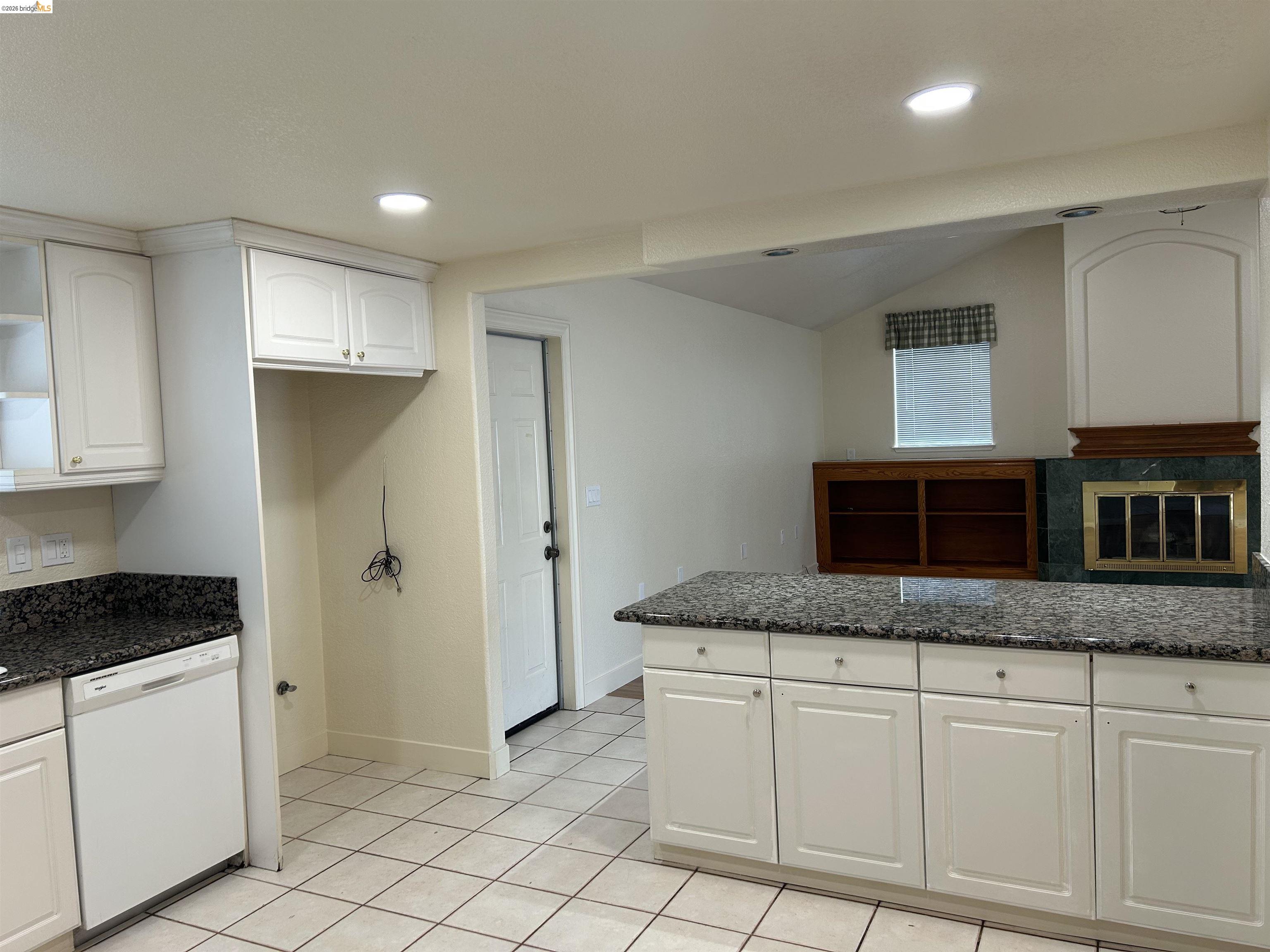 2632 Point Lobos Court Antioch, CA 94531 - Photo 27 of 27 Kitchen with white cabinetry, white dishwasher, dark stone counters, light tile patterned floors, and open floor plan