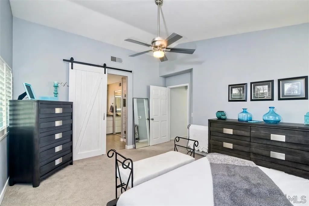 11564 Village Ridge Road San Diego, CA 92131 - Photo 15 of 25 a bedroom with a bed and a dresser
