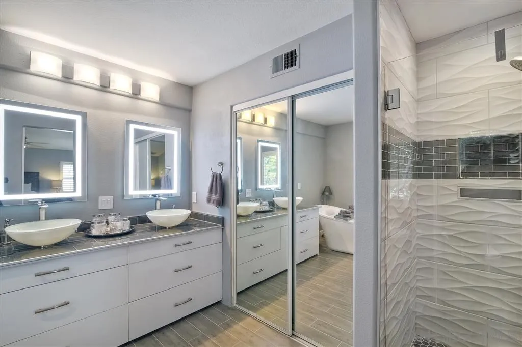 11564 Village Ridge Road San Diego, CA 92131 - Photo 16 of 25 a bathroom with a double vanity sink and a mirror