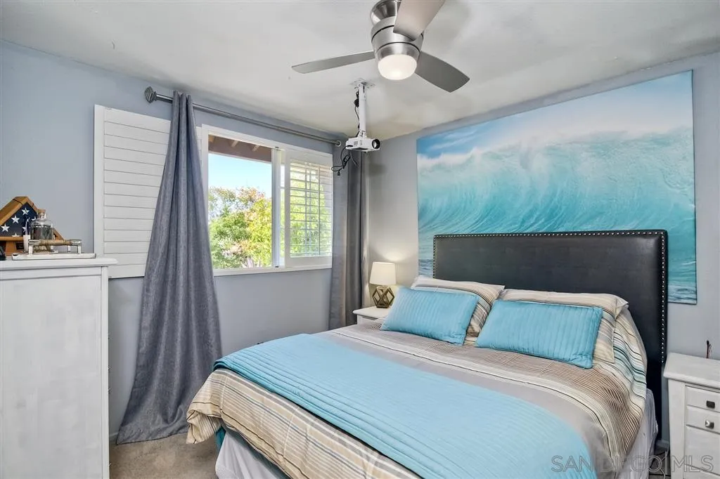 11564 Village Ridge Road San Diego, CA 92131 - Photo 21 of 25 a bedroom with a bed and a chandelier