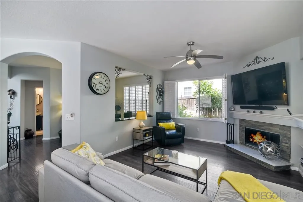 11564 Village Ridge Road San Diego, CA 92131 - Photo 8 of 25 a living room with furniture a fireplace and a flat screen tv