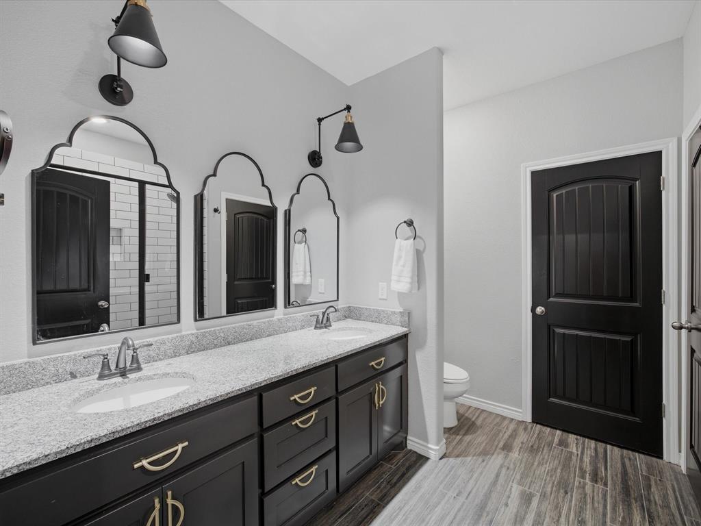 117 Ranchview Court Bowie, TX 76230 - Photo 16 of 40 a spacious bathroom with a double vanity sink and a mirror