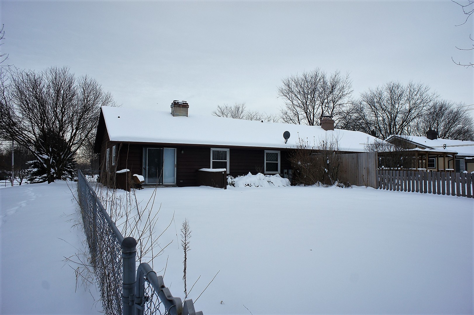422 Ranch Road Elgin, IL 60123 - Photo 2 of 2 a front view of a house with a yard covered with snow in front of house