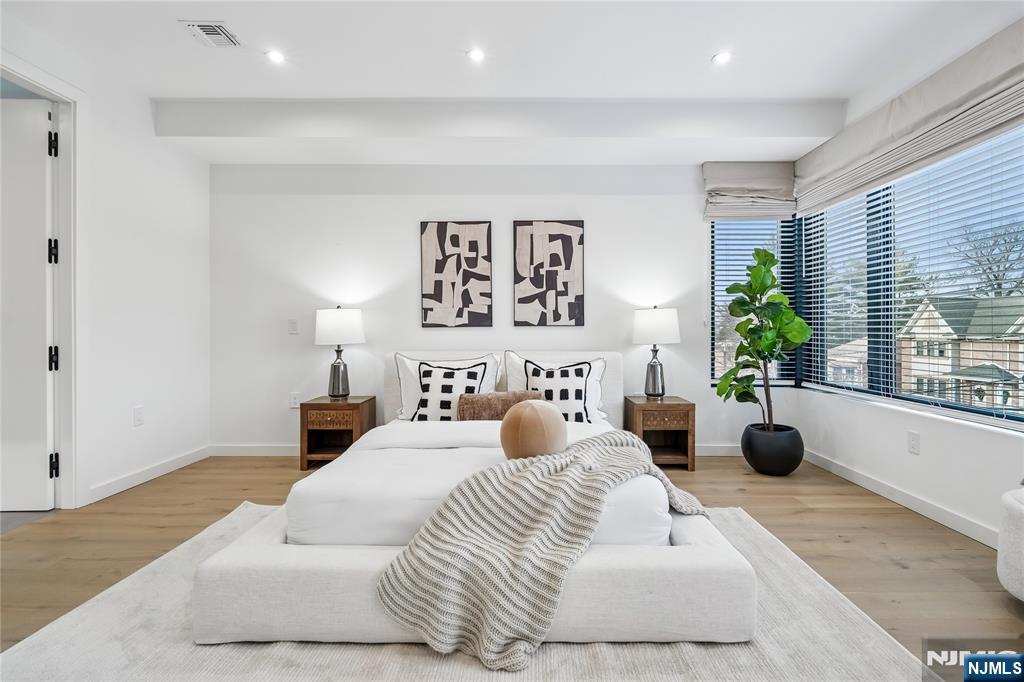 426 Aurora Avenue Cliffside Park, NJ 07010 - Photo 11 of 38 a bedroom with a bed a couch and potted plant