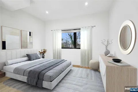 a bedroom with a bed and a mirror