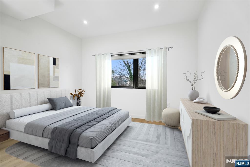 426 Aurora Avenue Cliffside Park, NJ 07010 - Photo 14 of 38 a bedroom with a bed and a mirror