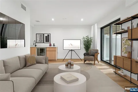 a living room with furniture and a floor to ceiling window