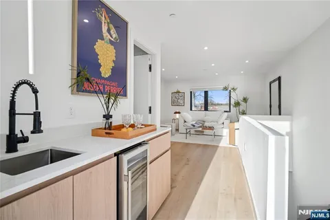 a kitchen with stainless steel appliances granite countertop a sink and dishwasher a stove with wooden floor