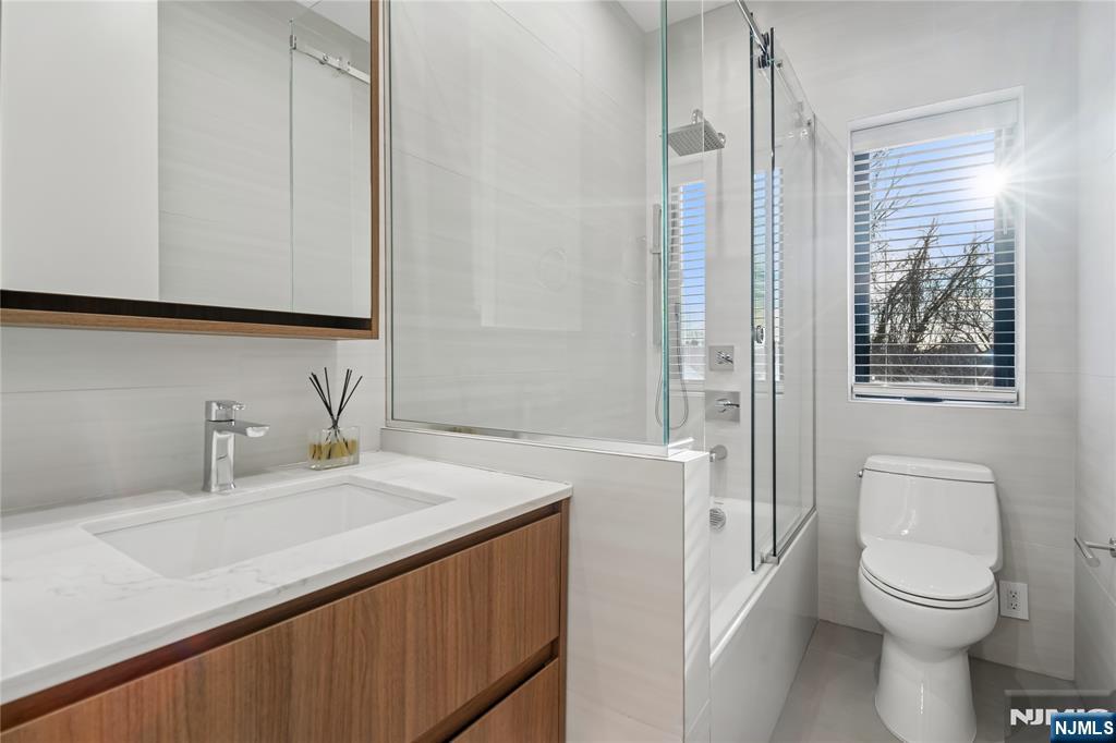 426 Aurora Avenue Cliffside Park, NJ 07010 - Photo 21 of 38 a bathroom with a sink a toilet and a mirror